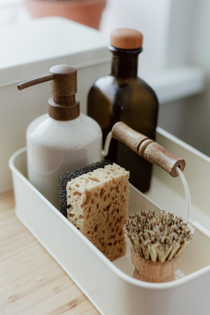 services-02 Close-up of elegant kitchen cleaning essentials in a minimalist organizer.